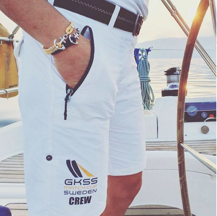 Sailor at the helm wearing anchor bracelets